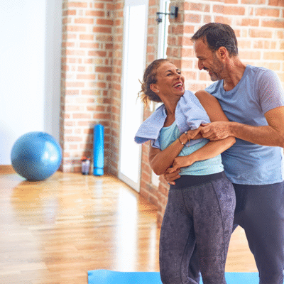Happy couple playfully dancing after a yoga session.